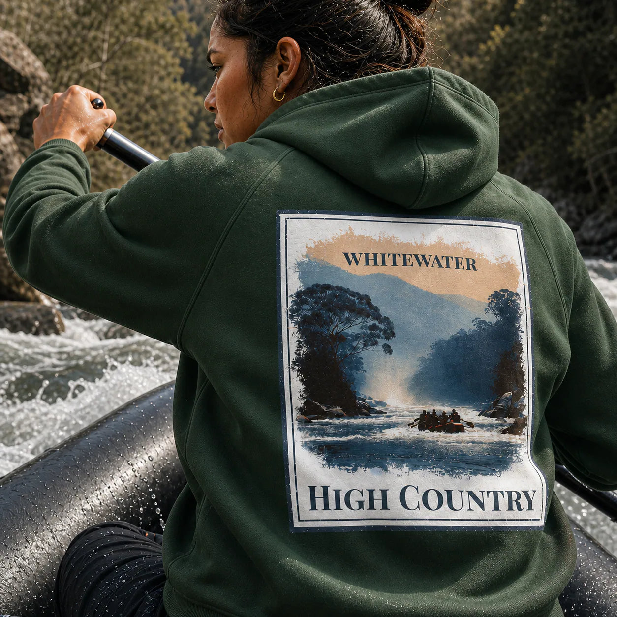 Eco hoodie in dark green with back graphic patch reading “WHITEWATER” and “HIGH COUNTRY”