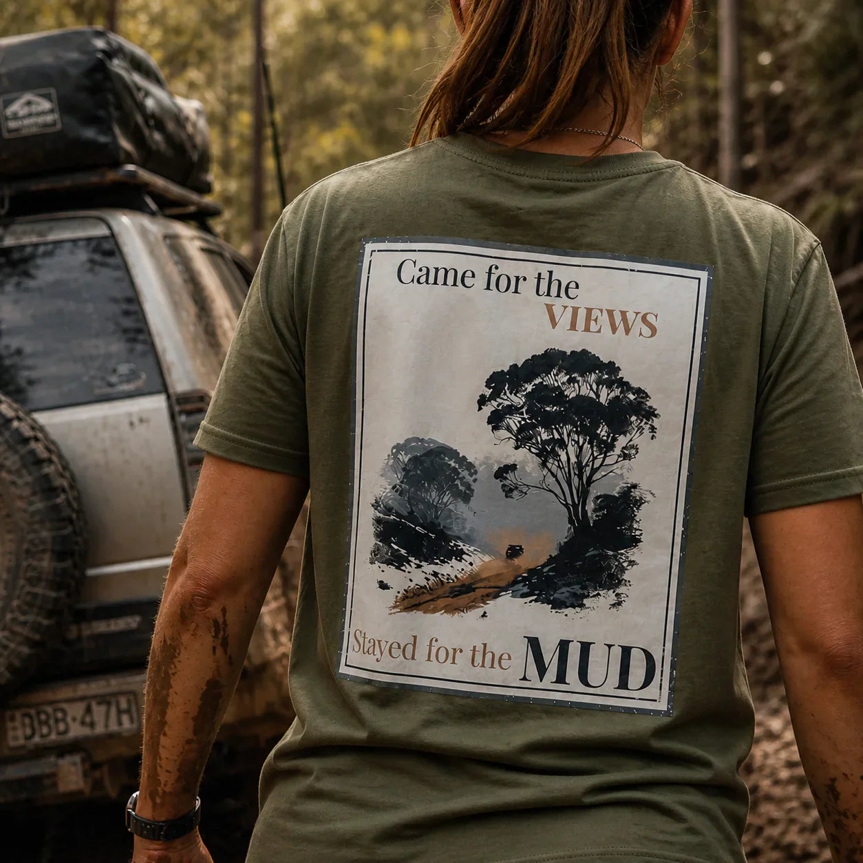 Organic tee in olive green with back graphic: “Came for the Views… Stayed for the Mud”