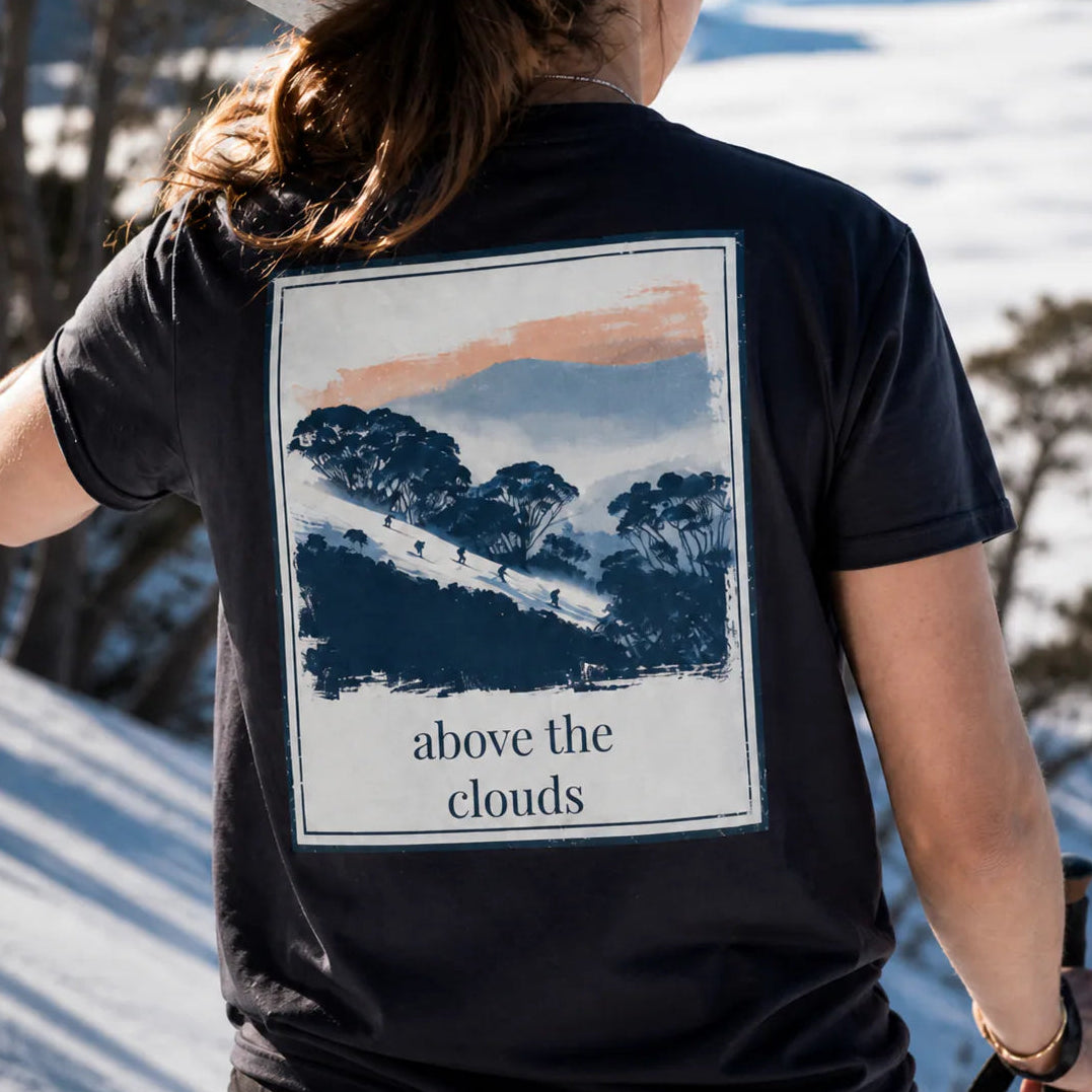 Black organic tee with back square landscape graphic and “above the clouds”