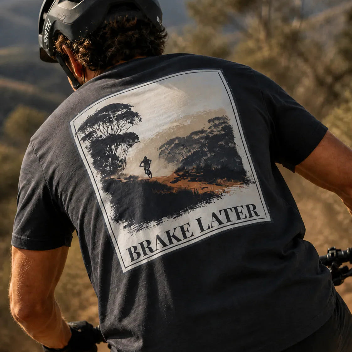 Organic Tee “Brake Later” graphic on dark grey/black back