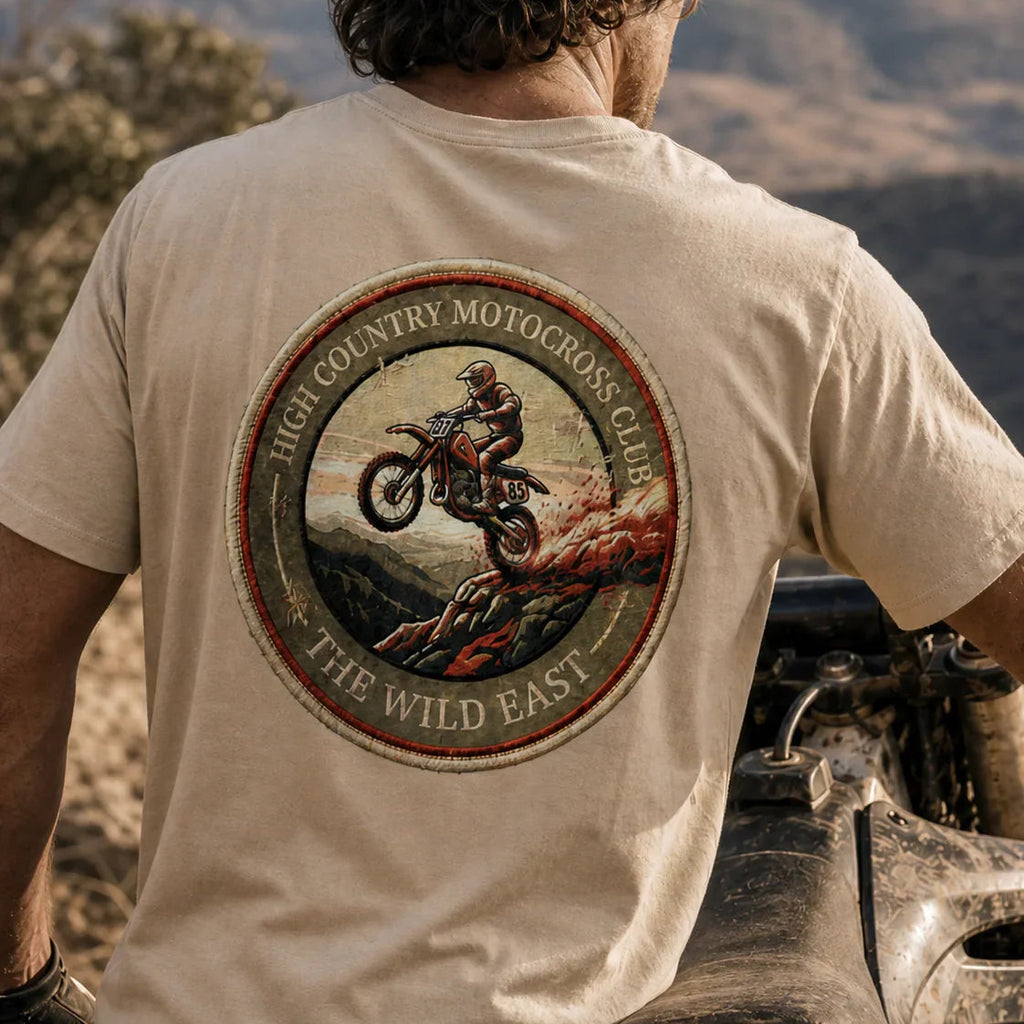 Light tan organic tee with round motocross club graphic patch on back