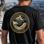 Black organic tee, back print of skier badge with text “The Wild East”