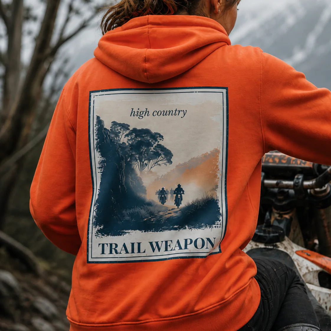 Eco hoodie in burnt orange with hood and kangaroo pocket, large back landscape graphic