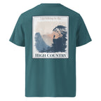Teal organic tee with back hiking landscape graphic and “HIGH COUNTRY” text
